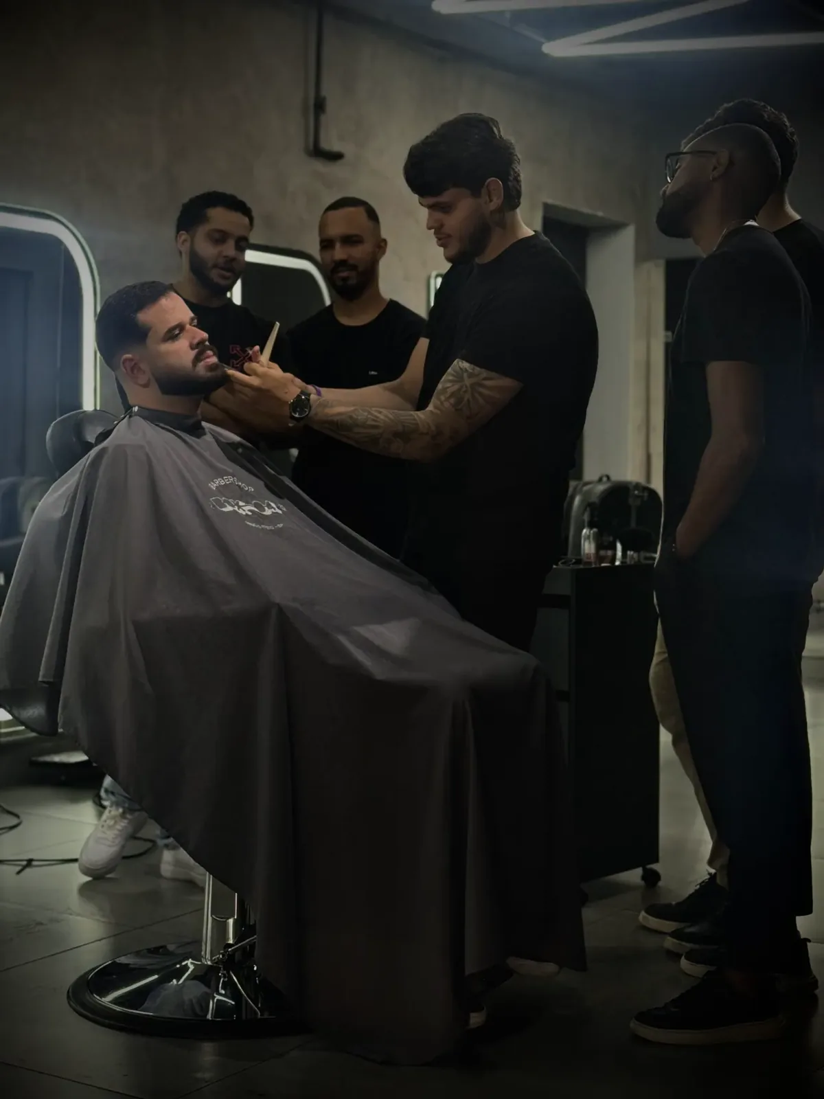 Nicolas orientando alunos durante o treinamento prático na barbearia